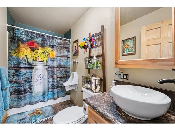 a living room with furniture a flat screen tv and a window