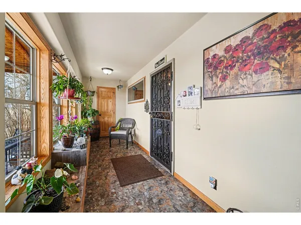 a balcony with furniture and a potted plant