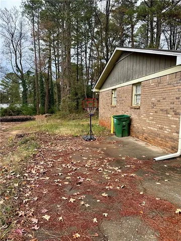 a view of backyard of house with green space