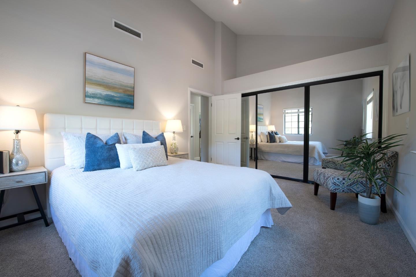 22344 Regnart Road Cupertino, CA 95014 - Photo 12 of 20 a spacious bedroom with a bed and a potted plant