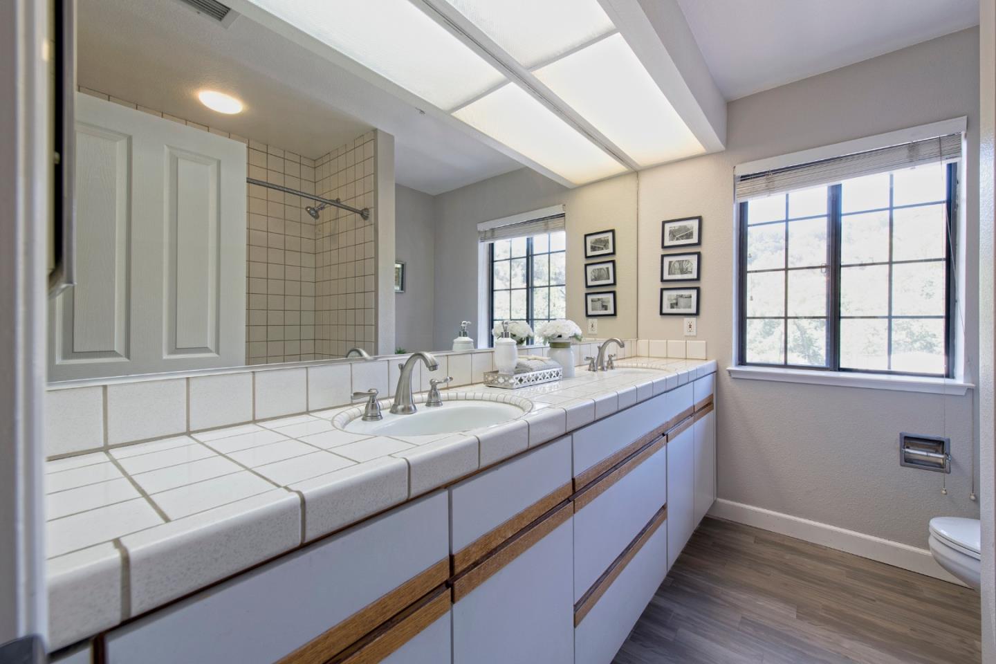 22344 Regnart Road Cupertino, CA 95014 - Photo 17 of 20 a bathroom with a sink and a mirror