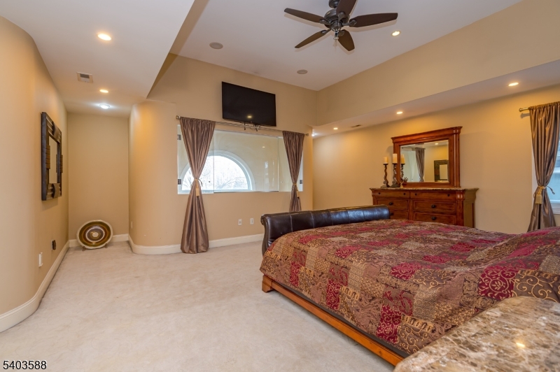 53 Princeton Avenue Woodbridge, NJ 07067 - Photo 26 of 37 a bedroom with a bed and a chandelier