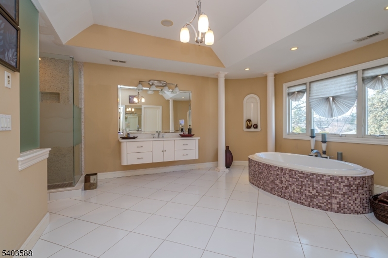 53 Princeton Avenue Woodbridge, NJ 07067 - Photo 28 of 37 a spacious bathroom with a granite countertop sink a mirror and a bathtub