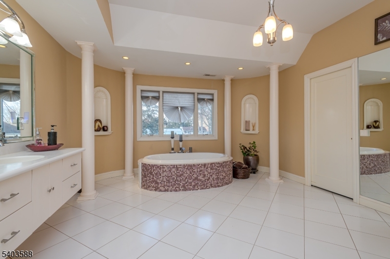 53 Princeton Avenue Woodbridge, NJ 07067 - Photo 29 of 37 a spacious bathroom with a granite countertop sink a mirror a vanity and shower