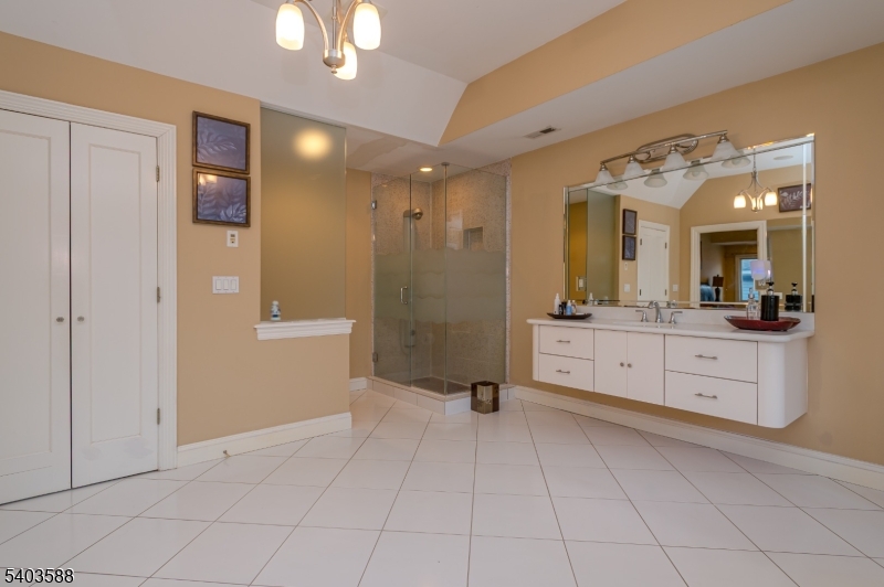 53 Princeton Avenue Woodbridge, NJ 07067 - Photo 30 of 37 a bathroom with a sink a mirror and a shower