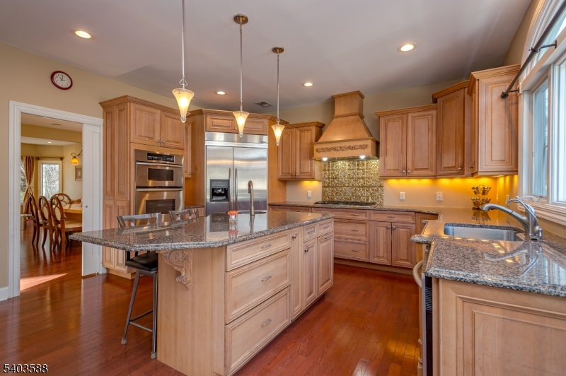 53 Princeton Avenue Woodbridge, NJ 07067 - Photo 10 of 37 a kitchen with stainless steel appliances granite countertop a sink a stove and a wooden floors