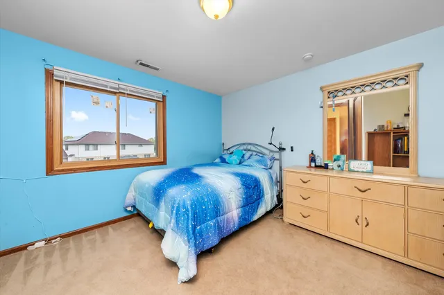 a bedroom with a bed and window