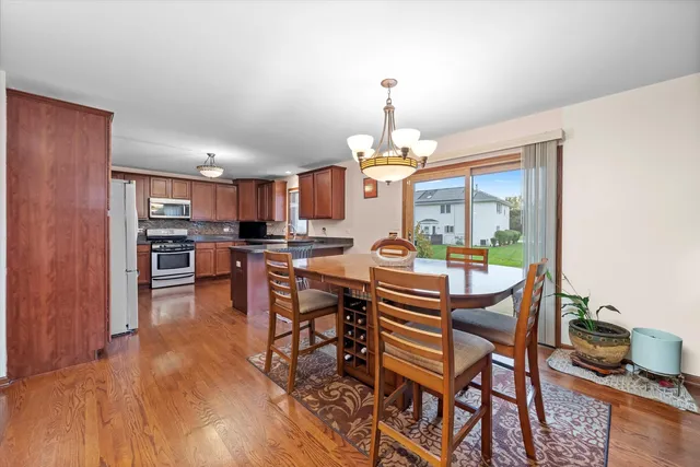 a dining room with furniture and wooden floor