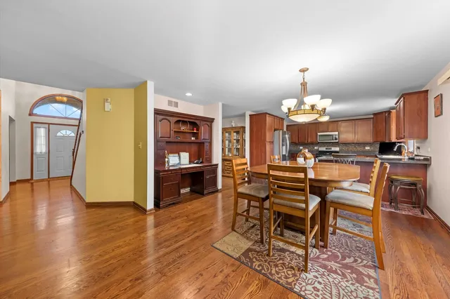 a view of a dining room with furniture and wooden floor