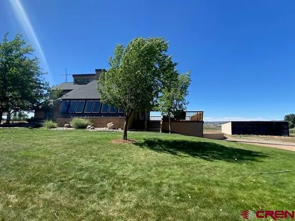 a view of a house with a backyard