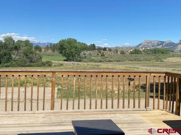 a view of a roof deck with wooden floor and fence