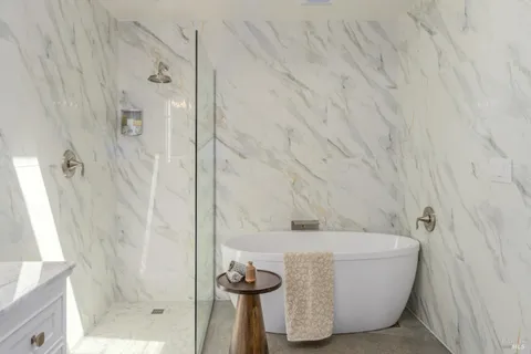 a bathroom with a bathtub and shower
