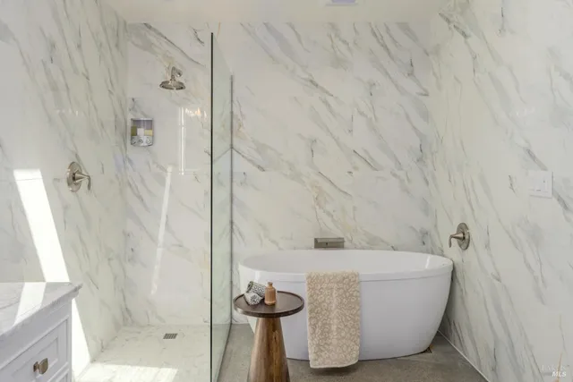 a bathroom with a bathtub and shower