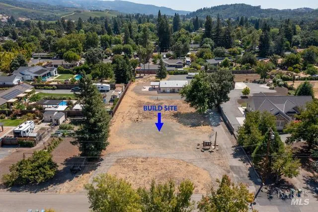 an aerial view of a houses with a road