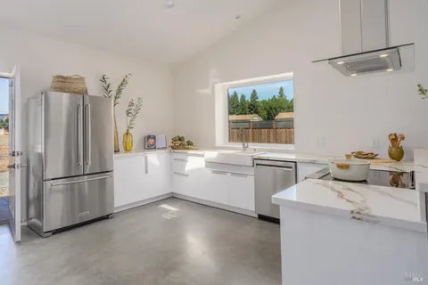 a kitchen with a refrigerator and a sink