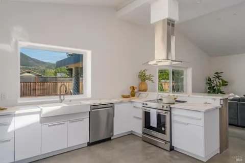 a kitchen with a sink stove and cabinets