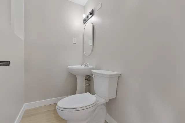 a white toilet sitting next to a white sink
