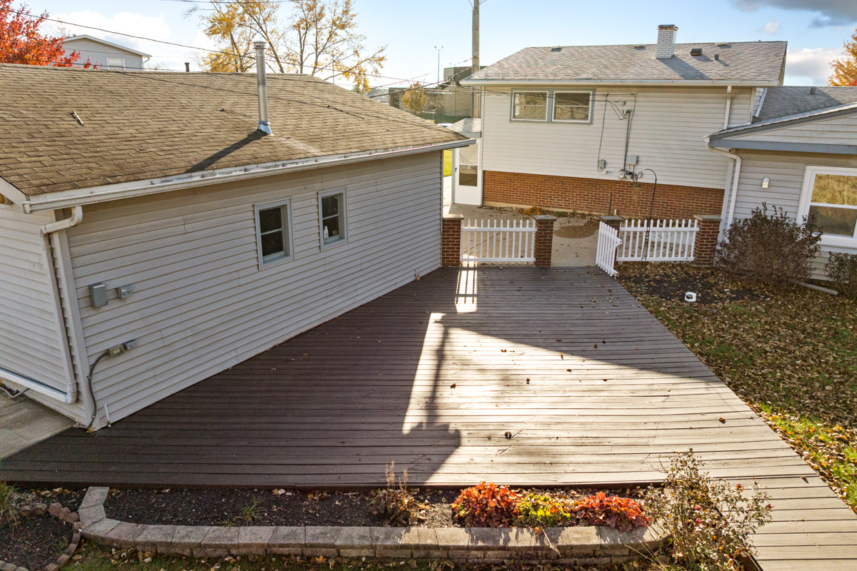 9446 Magnolia Avenue Mokena, IL 60448 - Photo 6 of 38 a view of a patio with table and chairs with wooden floor and fence