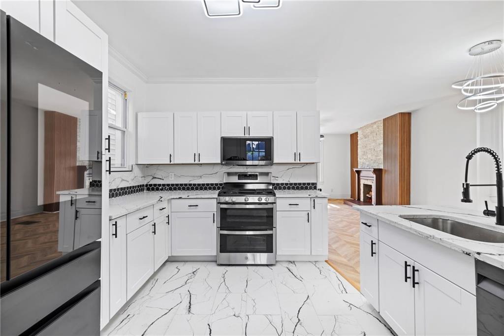 23 Craighead Street Pittsburgh, PA 15211 - Photo 16 of 35 a kitchen with granite countertop a sink stainless steel appliances and cabinets