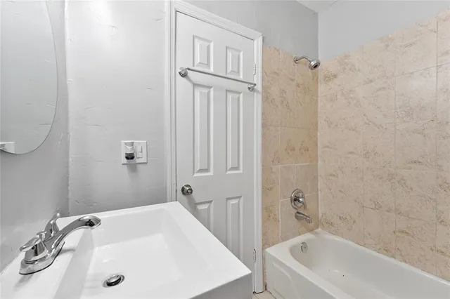 a bathroom with a tub and a sink