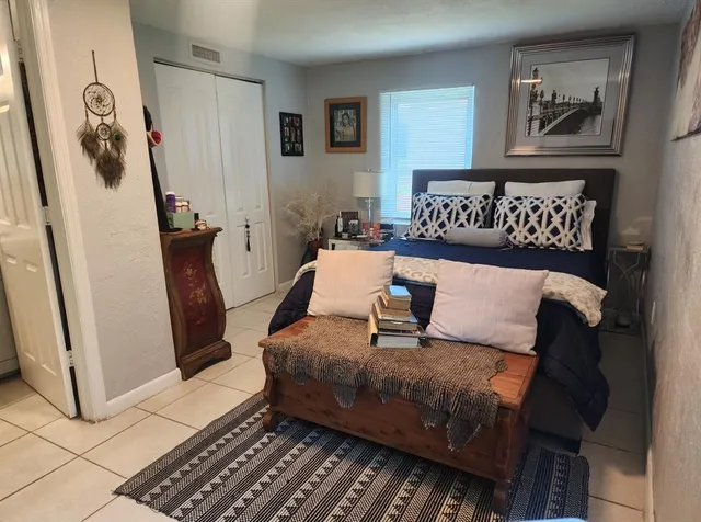 a bedroom with a bed and a window