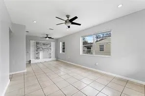 a view of a livingroom with a ceiling fan and window
