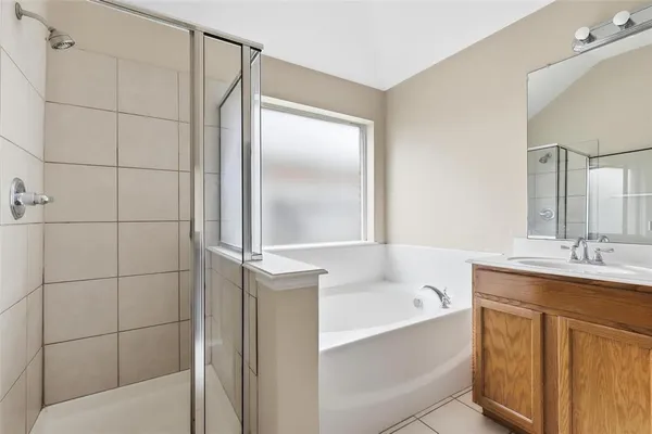 a bathroom with a bathtub and shower