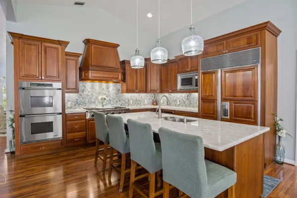 a kitchen with cabinets and stainless steel appliances