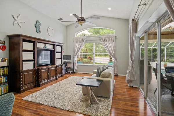 a living room with furniture a window and wooden floor