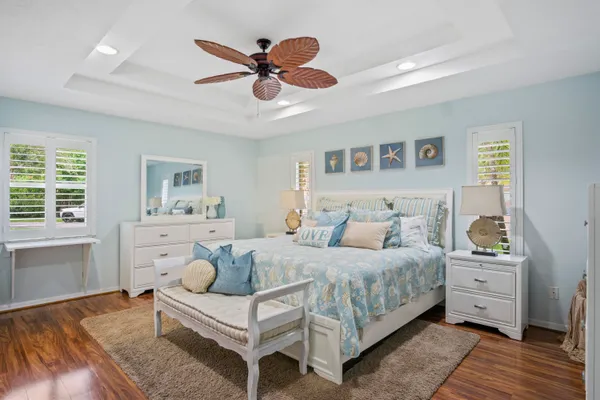 a bedroom with a large bed and a chandelier
