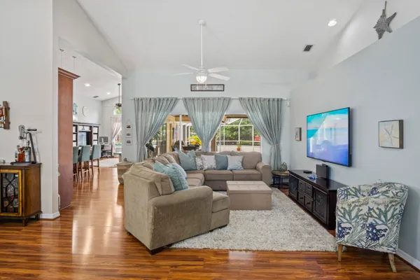 a living room with furniture and a wooden floor