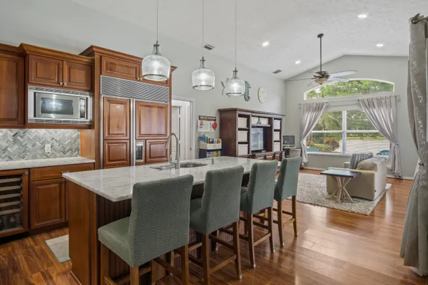 a large kitchen with cabinets table and chairs