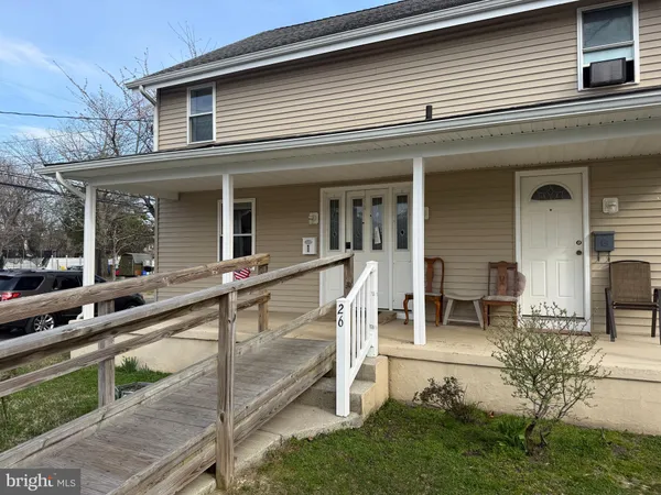 a view of a house with backyard and porch