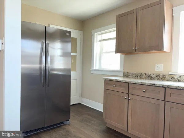 a kitchen with granite countertop cabinets and window
