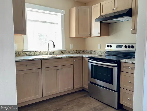 a kitchen with stainless steel appliances granite countertop a stove and a microwave