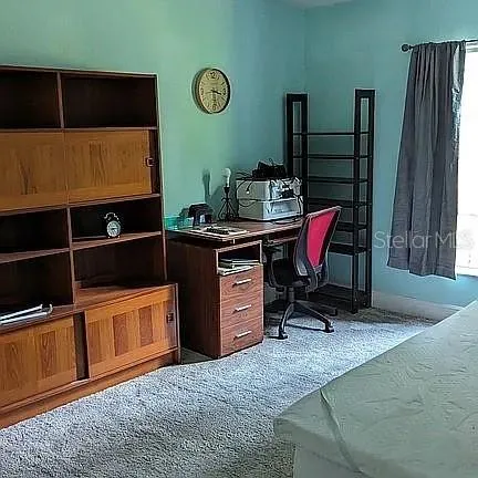 a bedroom with a bed and dresser
