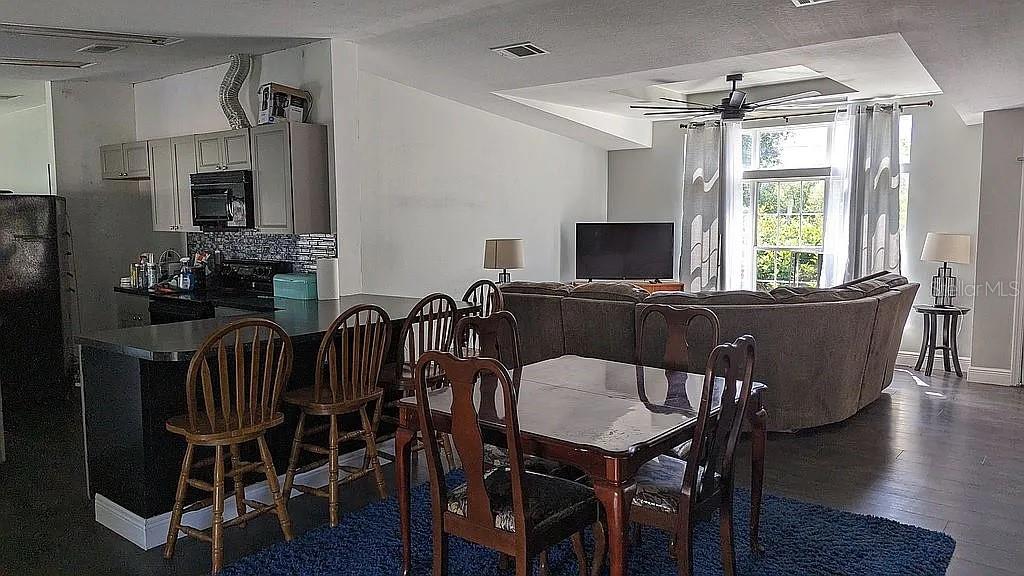 4402 Gallagher Road Plant City, FL 33565 - Photo 16 of 42 a view of a dining room with furniture window and wooden floor