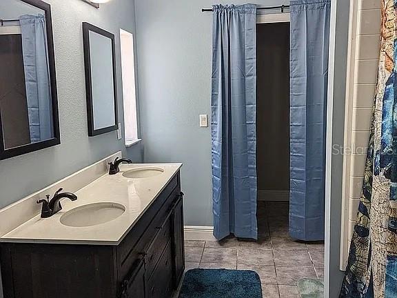 4402 Gallagher Road Plant City, FL 33565 - Photo 22 of 42 a bathroom with a sink and a mirror