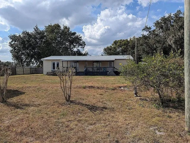 a view of a house with a large tree