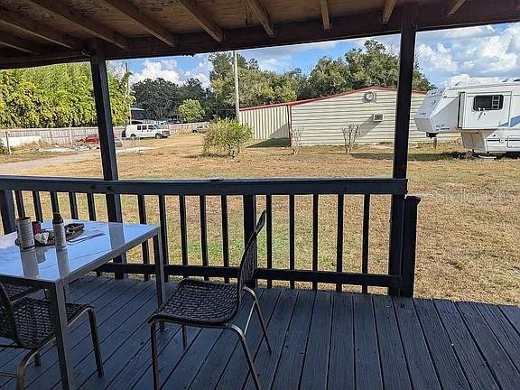 4402 Gallagher Road Plant City, FL 33565 - Photo 33 of 42 a view of a balcony with chairs and wooden floor
