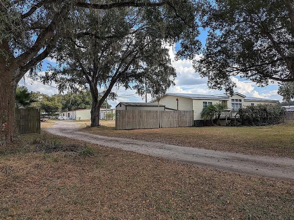 4402 Gallagher Road Plant City, FL 33565 - Photo 4 of 42 a front view of a house with a yard and garage