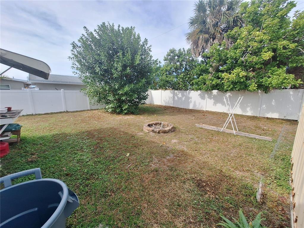 8564 Agress Avenue North Port, FL 34287 - Photo 16 of 18 a backyard of a house with lots of green space