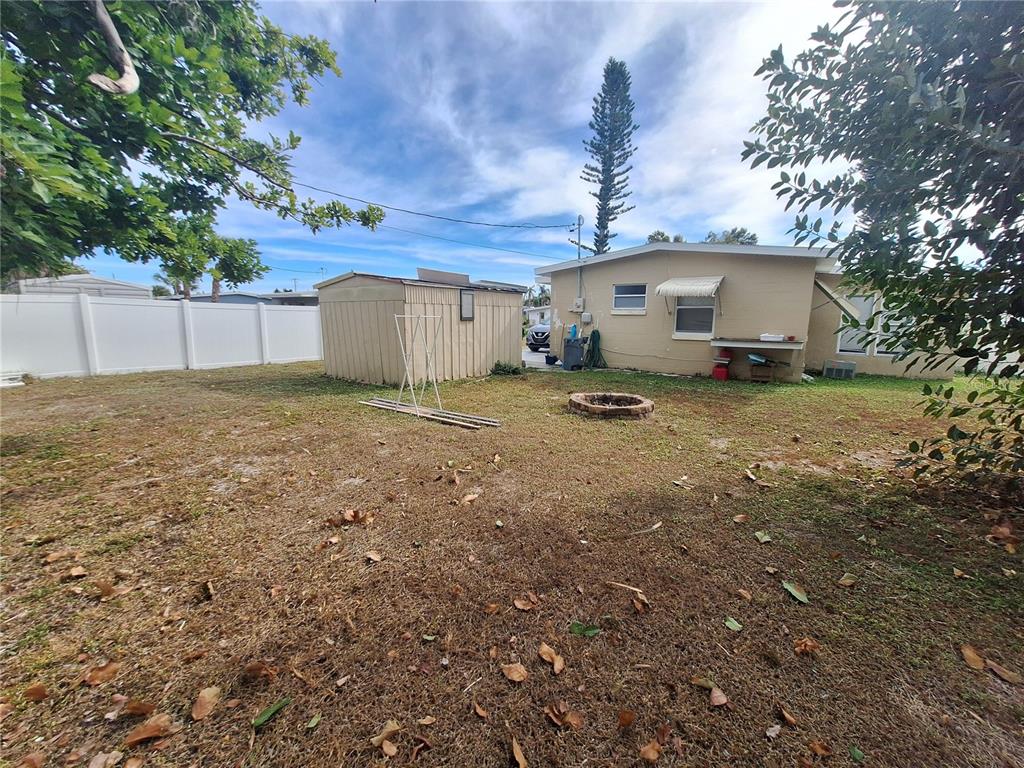 8564 Agress Avenue North Port, FL 34287 - Photo 17 of 18 a view of a house with a yard and garage