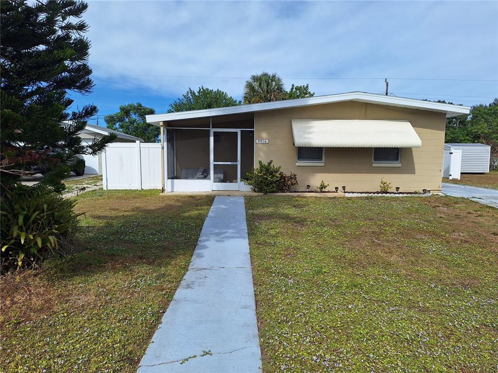 8564 Agress Avenue North Port, FL 34287 - Photo 2 of 18 a front view of a house with a garden