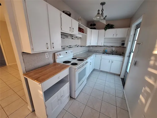a kitchen with stainless steel appliances a stove a sink and a refrigerator