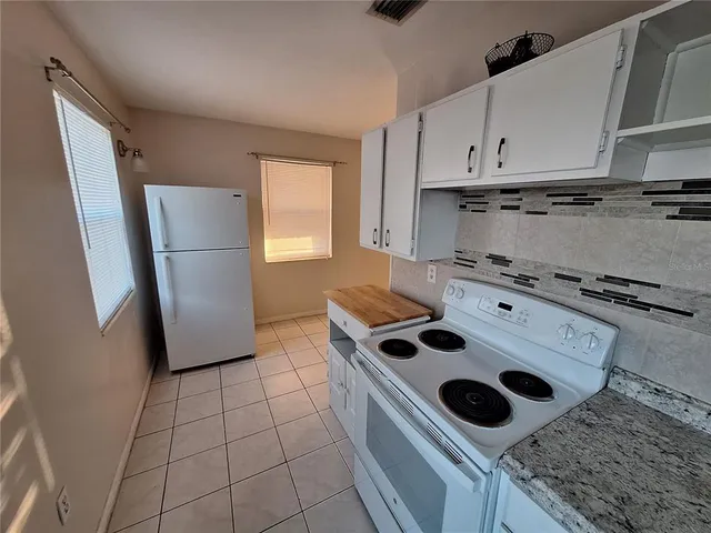 a kitchen with a stove a refrigerator and a sink