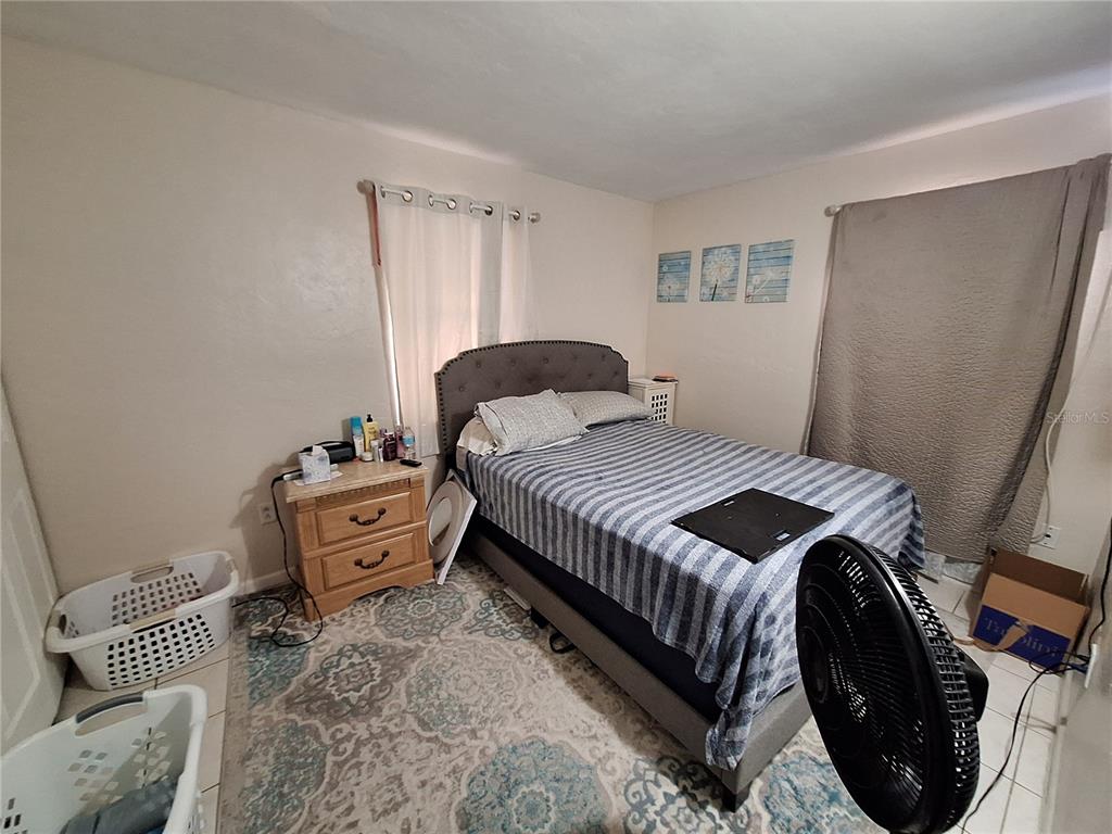 8564 Agress Avenue North Port, FL 34287 - Photo 7 of 18 a bedroom with a bed and a window