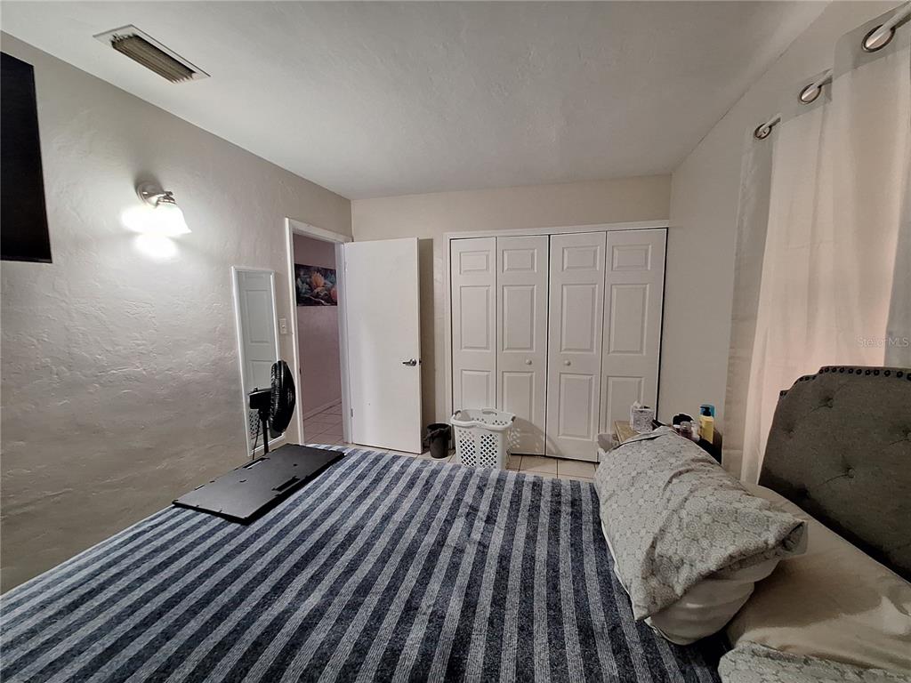 8564 Agress Avenue North Port, FL 34287 - Photo 8 of 18 a bed room with a bed and a couch
