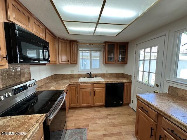 1210 Conway Lane, Unit 1210 Reno, NV 89503 - Photo 27 of 31 a kitchen with granite countertop a sink wooden cabinets and stainless steel appliances