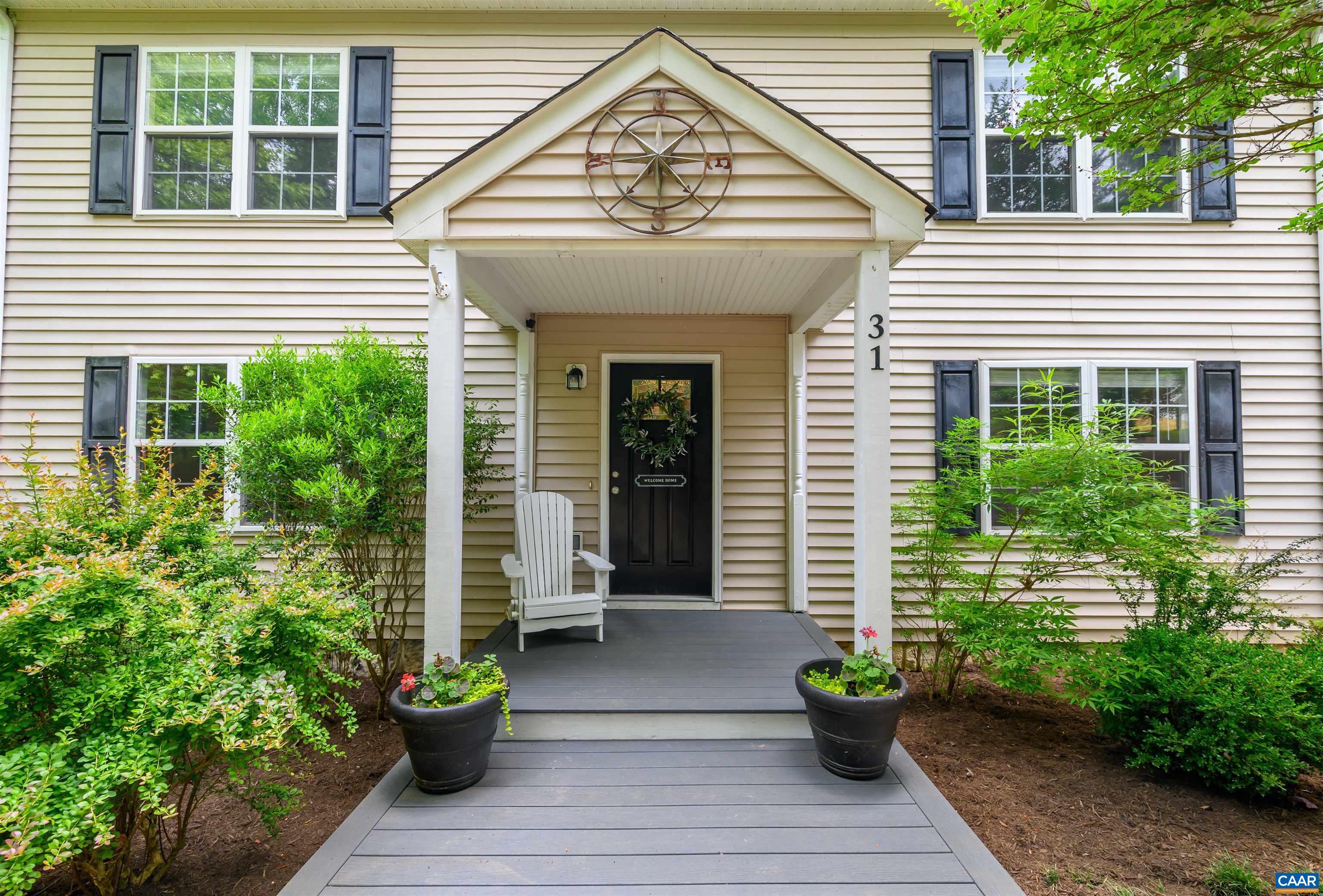 a view of a house with potted plants